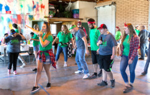 A larger group of guests dance at the Dance-A-Thon event